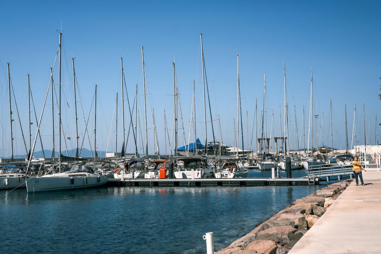 about-img-01 Scenic view of luxury yachts anchored at the marina in Foça, İzmir, Türkiye on a clear day.